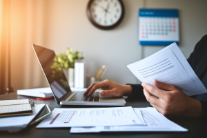 personne-bureau-ordinateur-papiers-horloge